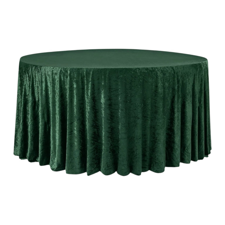Emerald greenvelvet tablecloth on a round table with a white background