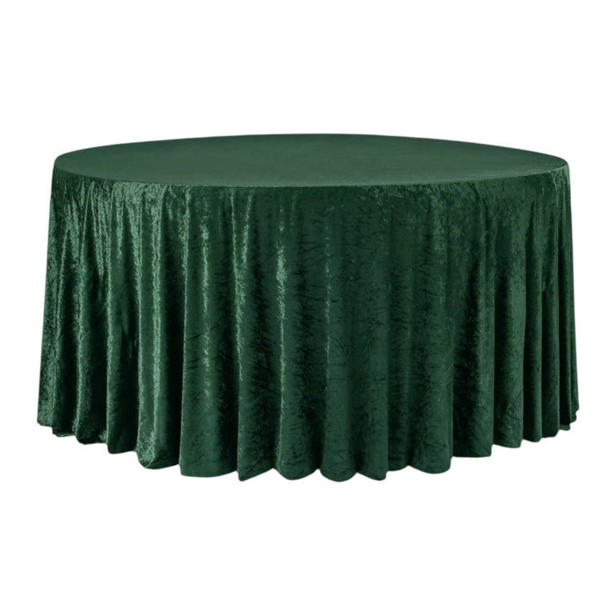 Emerald greenvelvet tablecloth on a round table with a white background