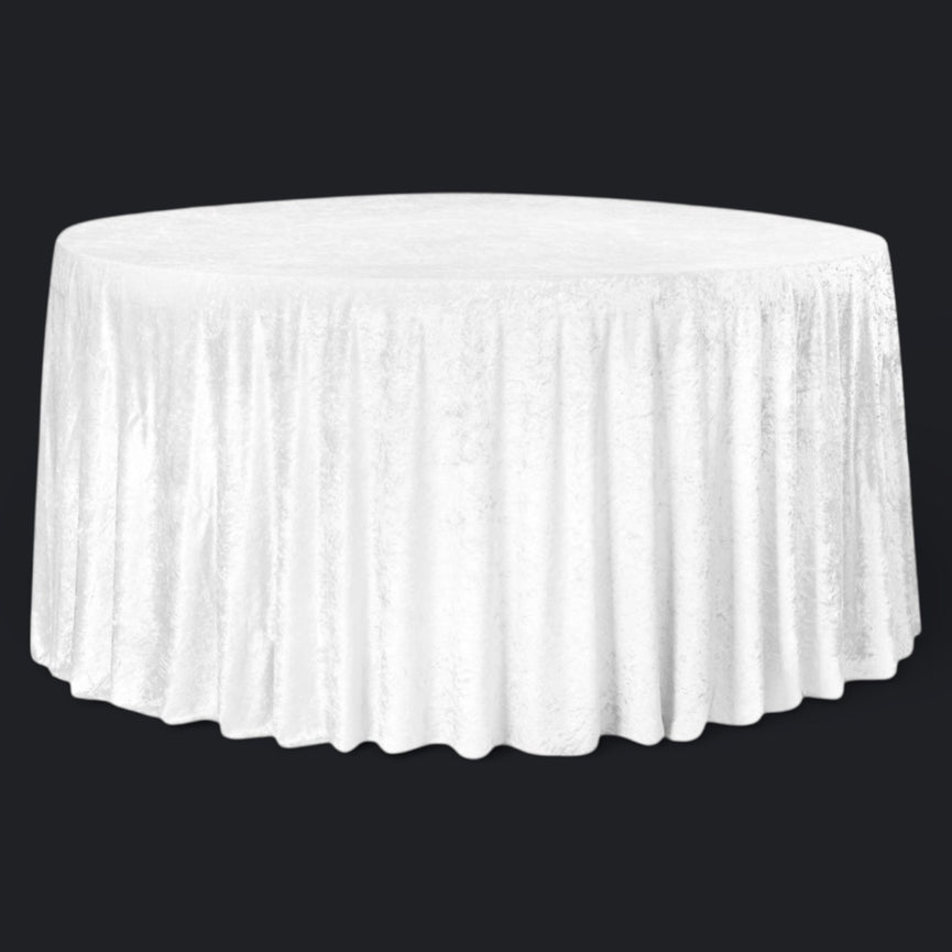 White round velvet tablecloth on a round table against a black background