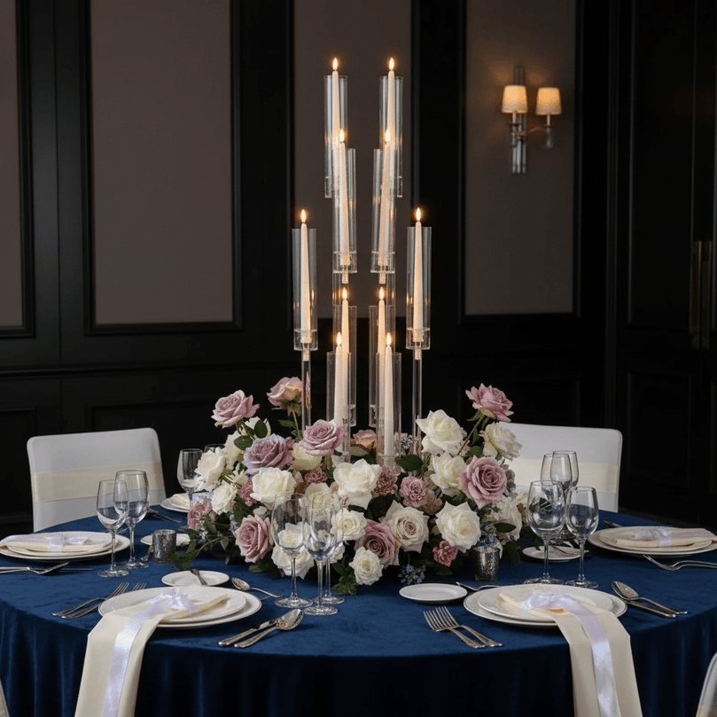 Elegant table setting with floral centerpiece and acrylic candleabra in a formal dining room.
