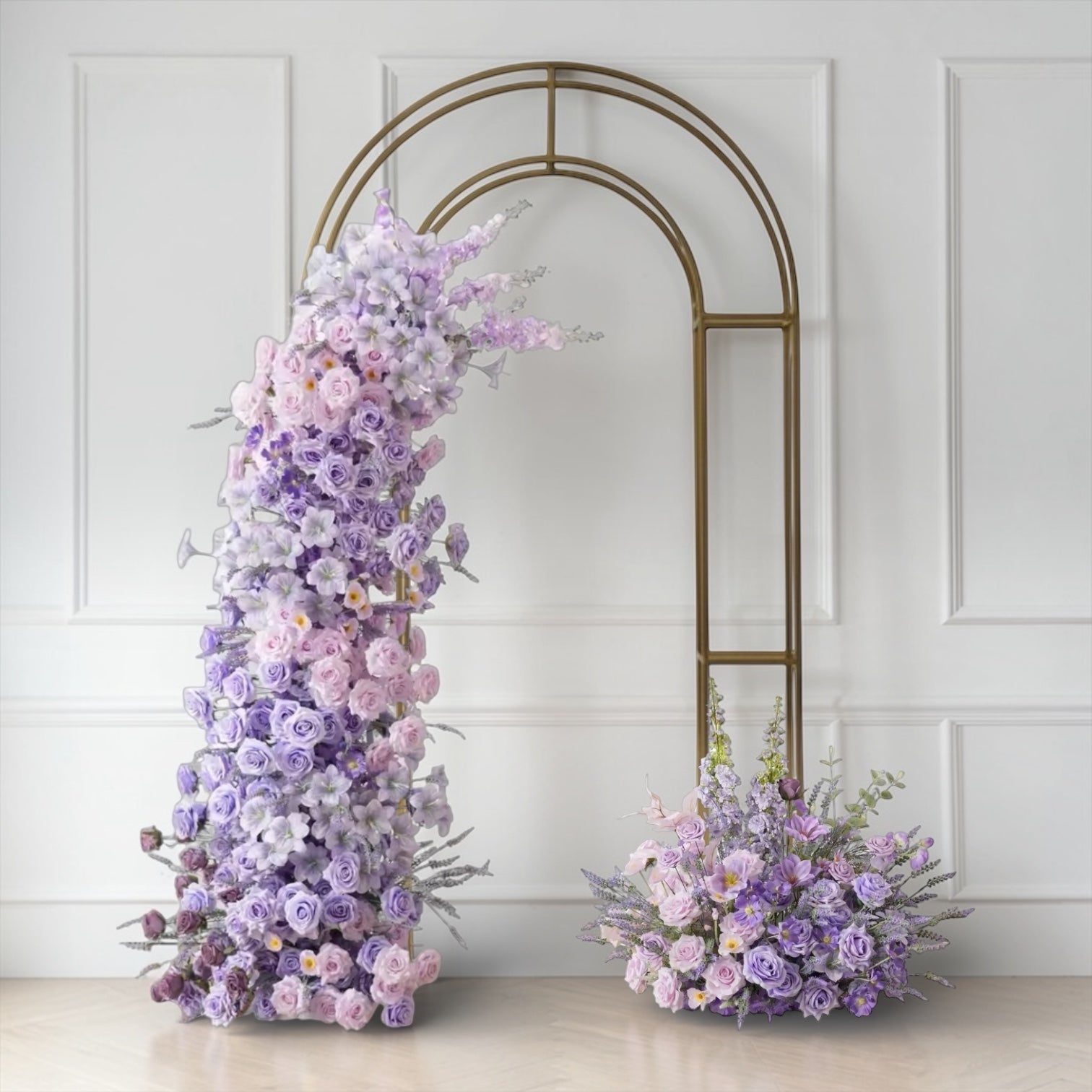 Wedding Floral arch and arrangements against a white wall with a decorative arch.