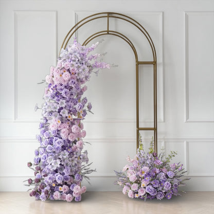 Wedding Floral arch and arrangements against a white wall with a decorative arch.