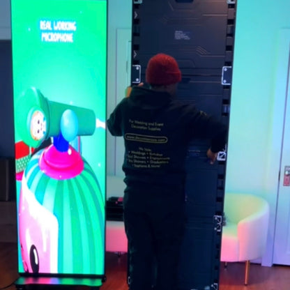 Person standing in front of a large screen displaying a colorful character with a megaphone.