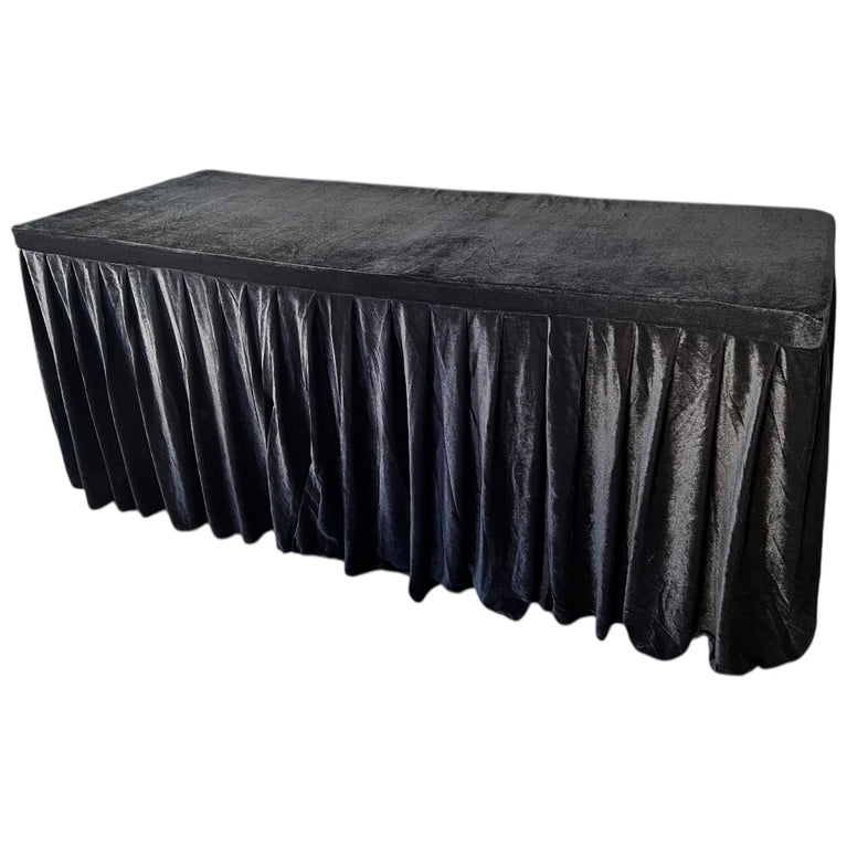 Black tablecloth with a pleated skirt on a white background