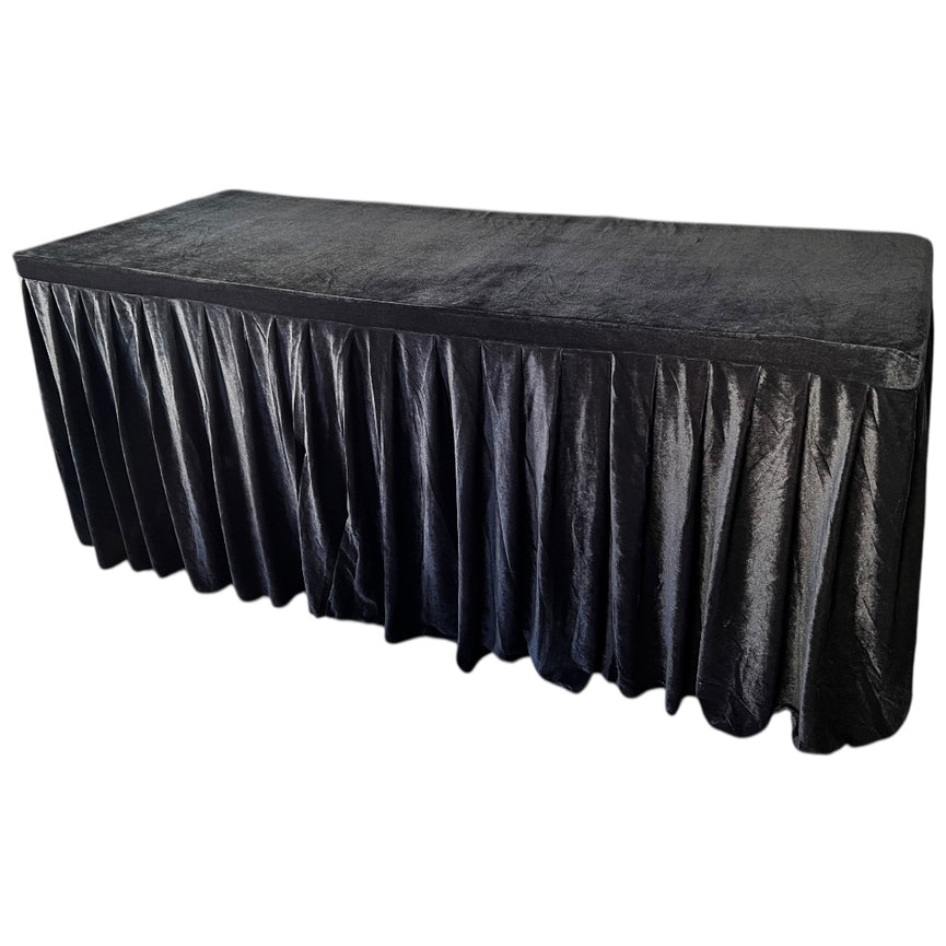 Black tablecloth with a pleated skirt on a white background