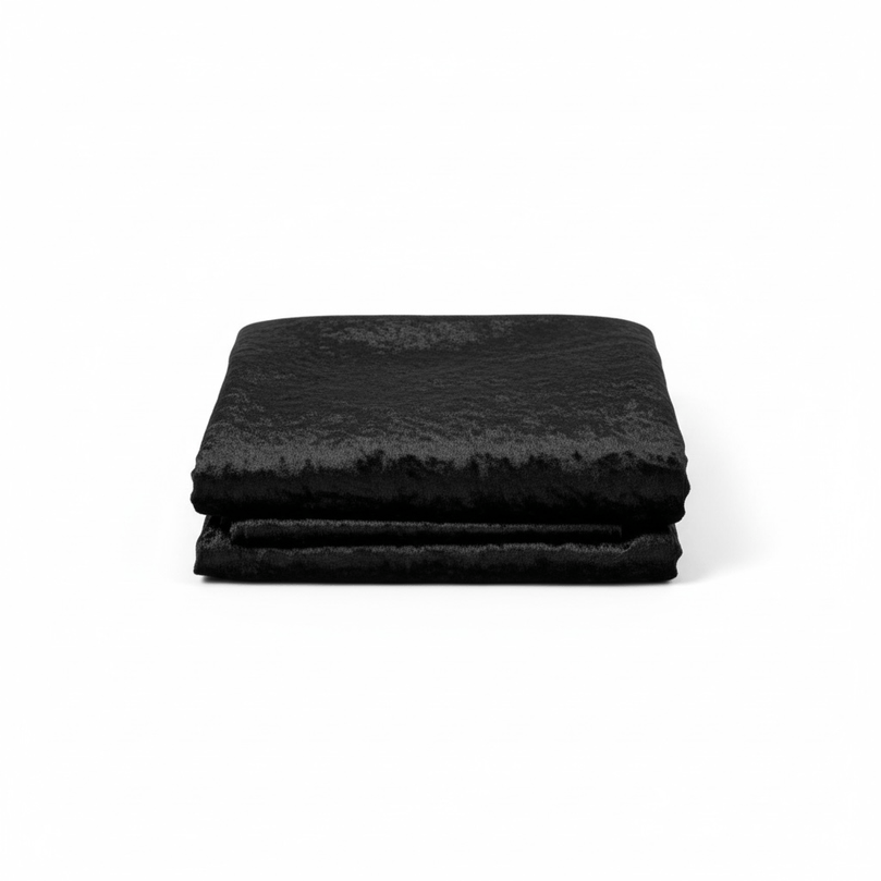Stack of black velvet fabric  on a white background