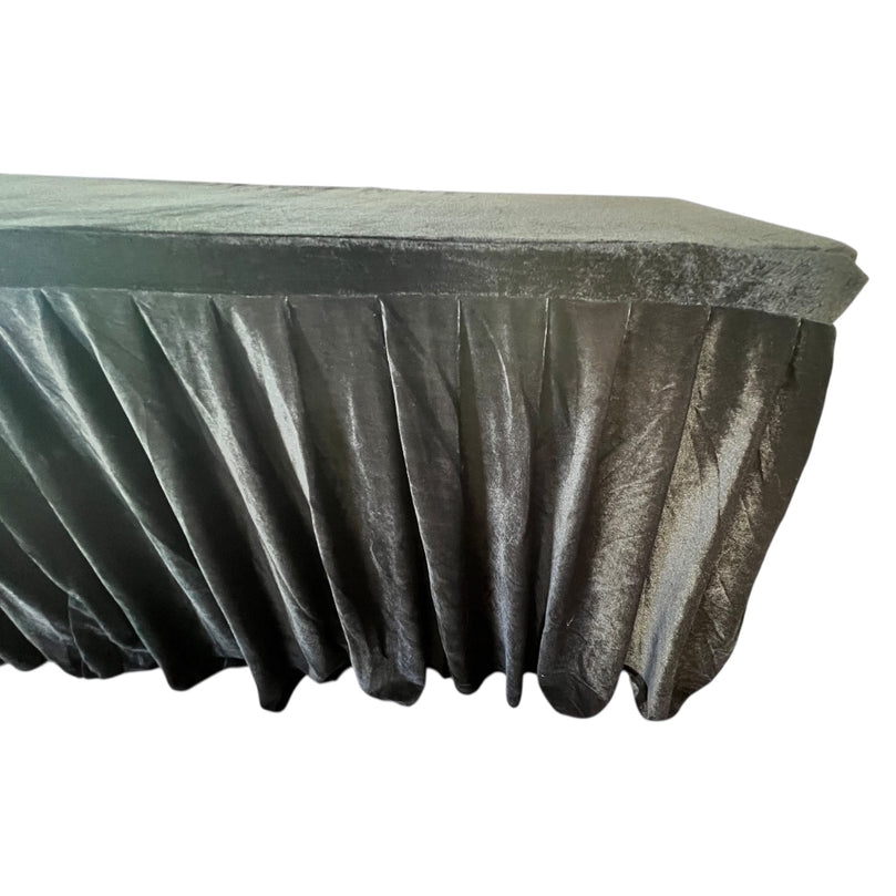 Black velvet tablecloth draped over a round table on a white background