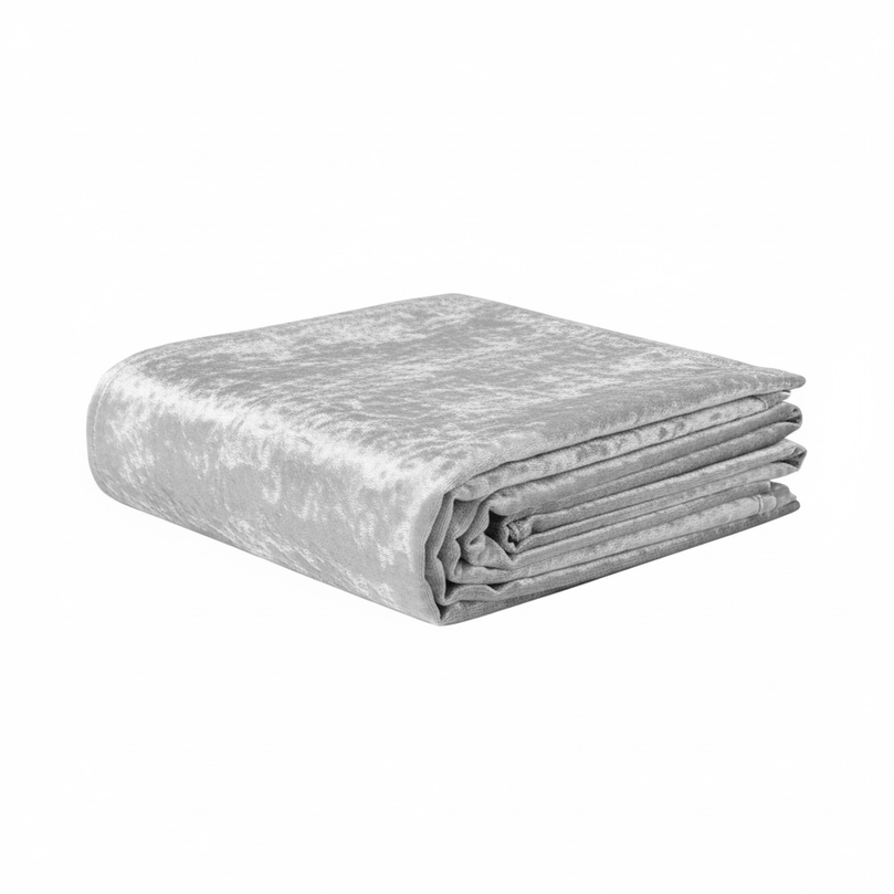 Folded silver velvet tablecloth on a white background