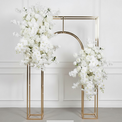 Gold wedding arch with white floral decorations against a white background