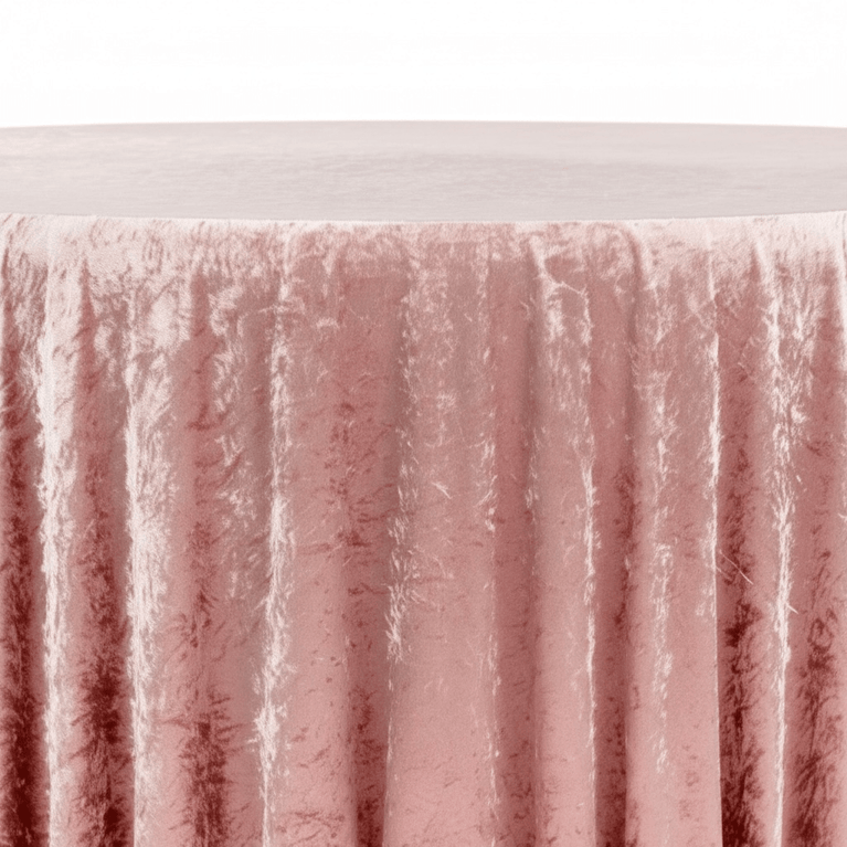 Close-up of a textured dusty pink velvet tablecloths with a white background