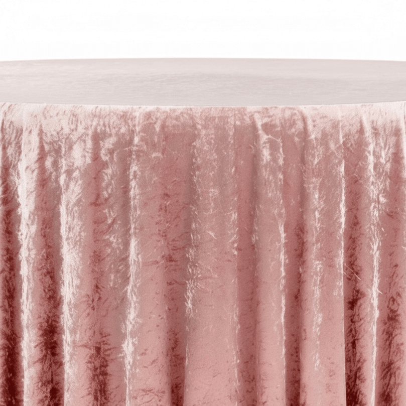 Close-up of a textured dusty pink velvet tablecloths with a white background