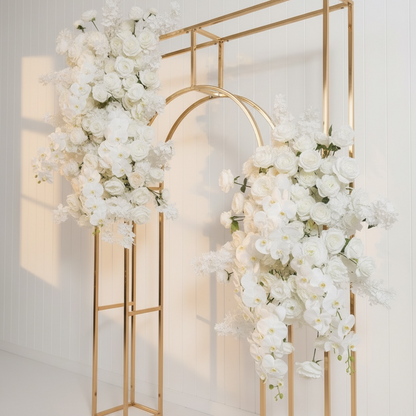 Decorative gold arch with white floral arrangements on a light background