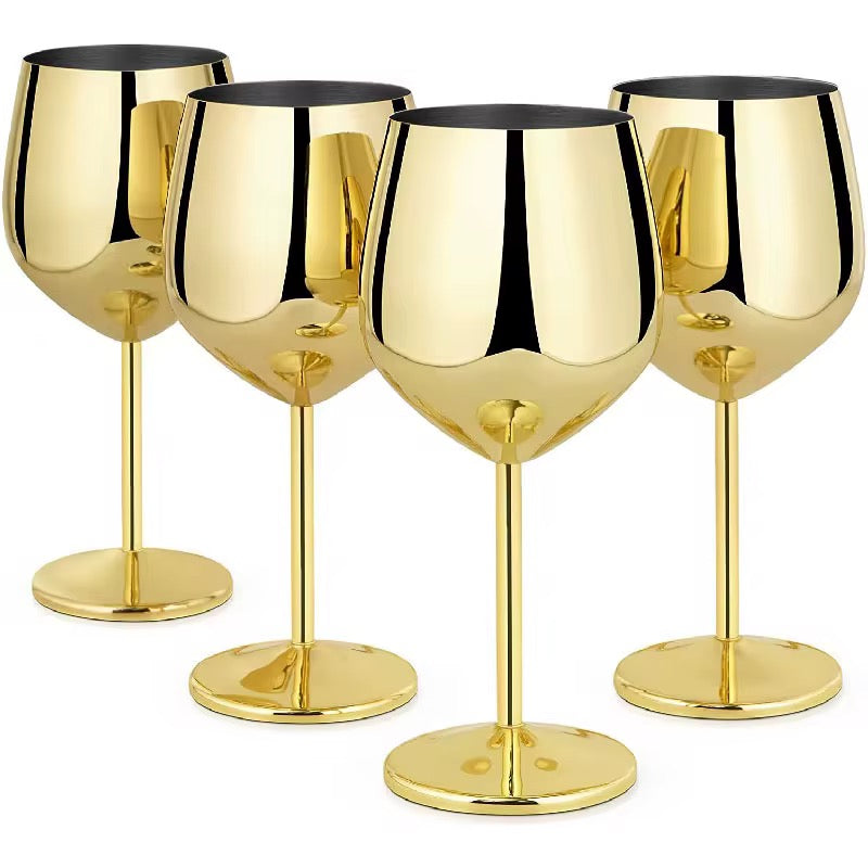 Set of four gold wine glasses on a white background