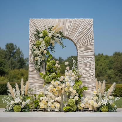 Decorative arch with floral arrangements against a clear blue sky