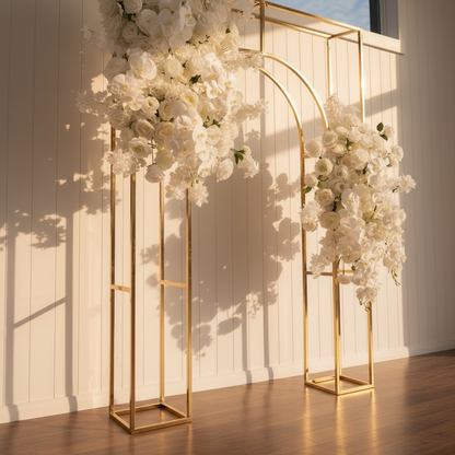 Gold arch with white flowers against a light wooden panel background