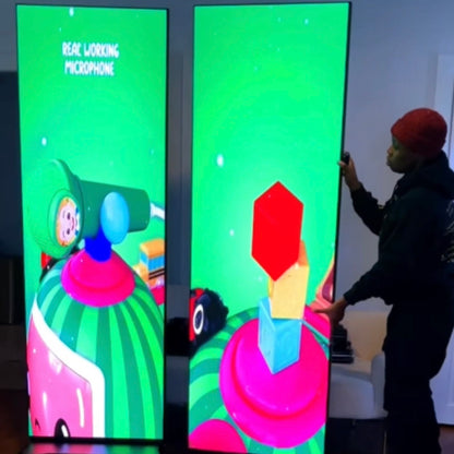 Person interacting with a colorful digital display featuring cartoon characters.