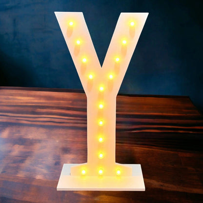 marquee light up letter Y standing on a wooden floor