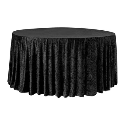 Black round velvet tablecloth on a round table against a white background