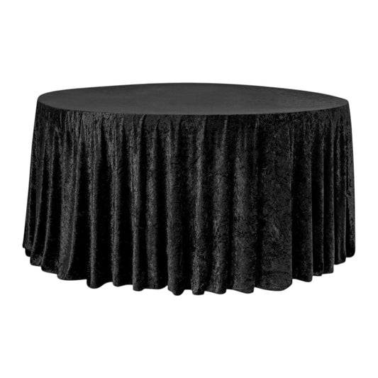 Black round velvet tablecloth on a round table against a white background