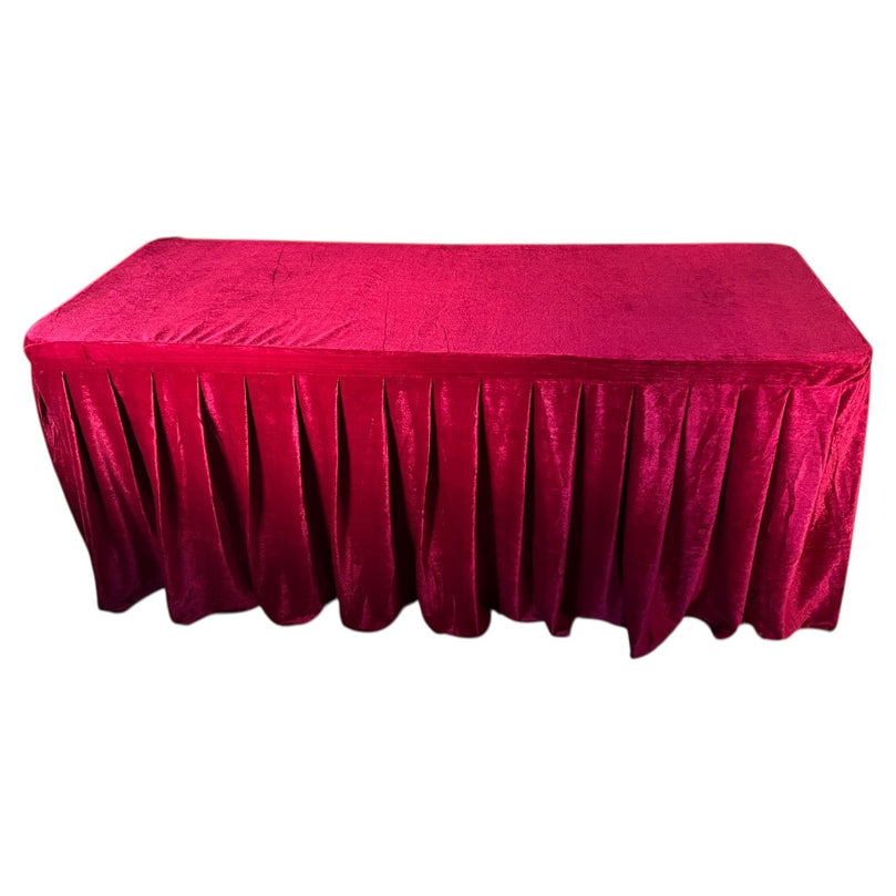 Burgundy tablecloth on a rectangular table with a white background