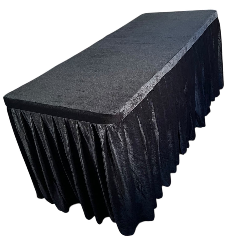 Black tablecloth draped over a rectangular table on a white background