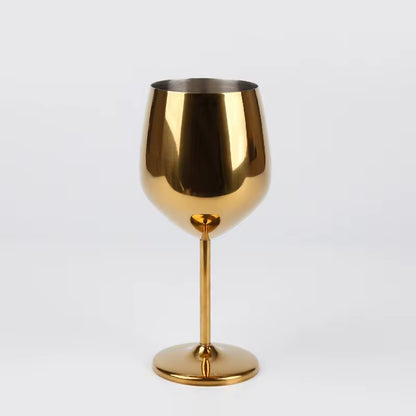 Gold wine glass on a light gray background