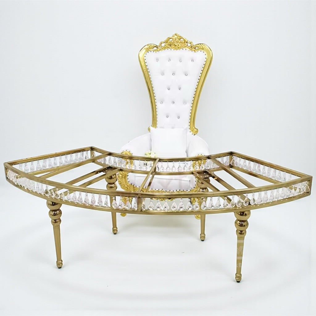 Decorative throne chair with gold frame and white cushion on a white background standing behind a crystal table