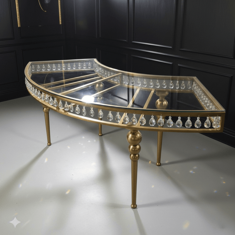Gold and crystal half-moon table against a black paneled wall.