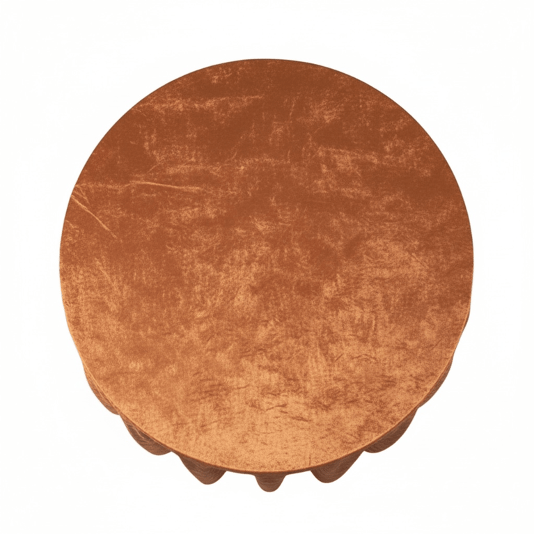 Round table with a textured terracotta velvet tablecloth a white background