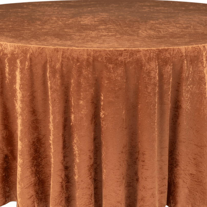 Round table with a terracotta pleated velvet tablecloth