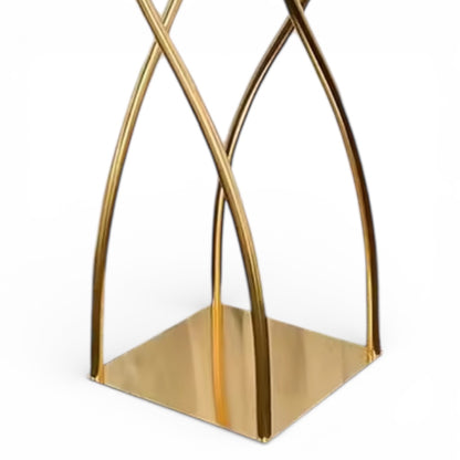 Upclose of a gold geometric decorative centerpiece base on a white background
