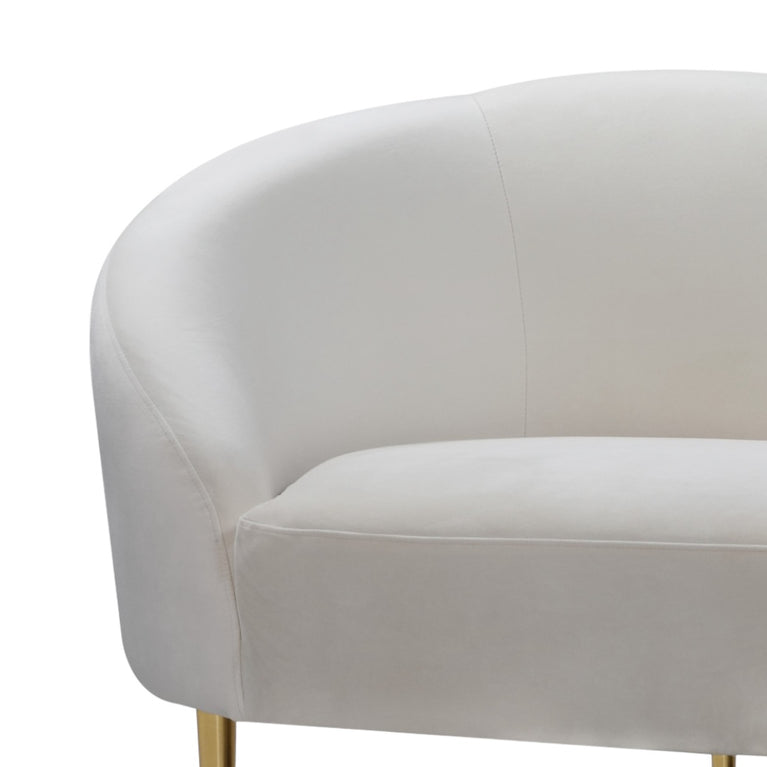 Beige upholstered chair with gold legs on a white background