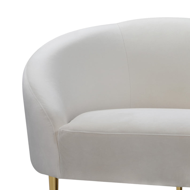 Beige upholstered chair with gold legs on a white background