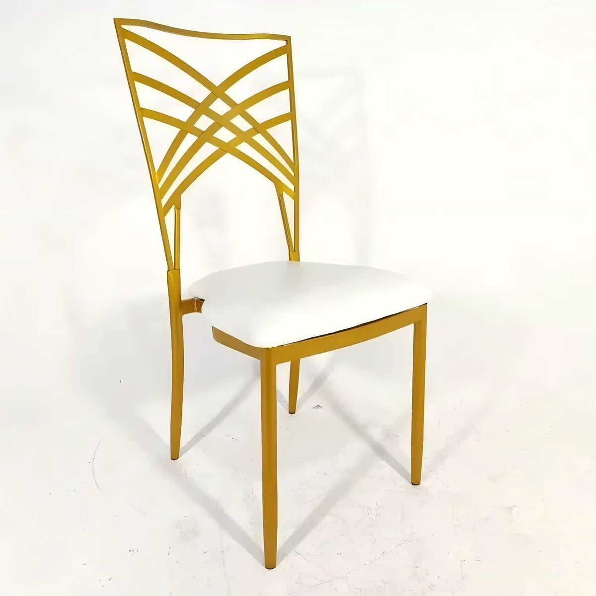 Gold chair with a white cushion on a light gray background
