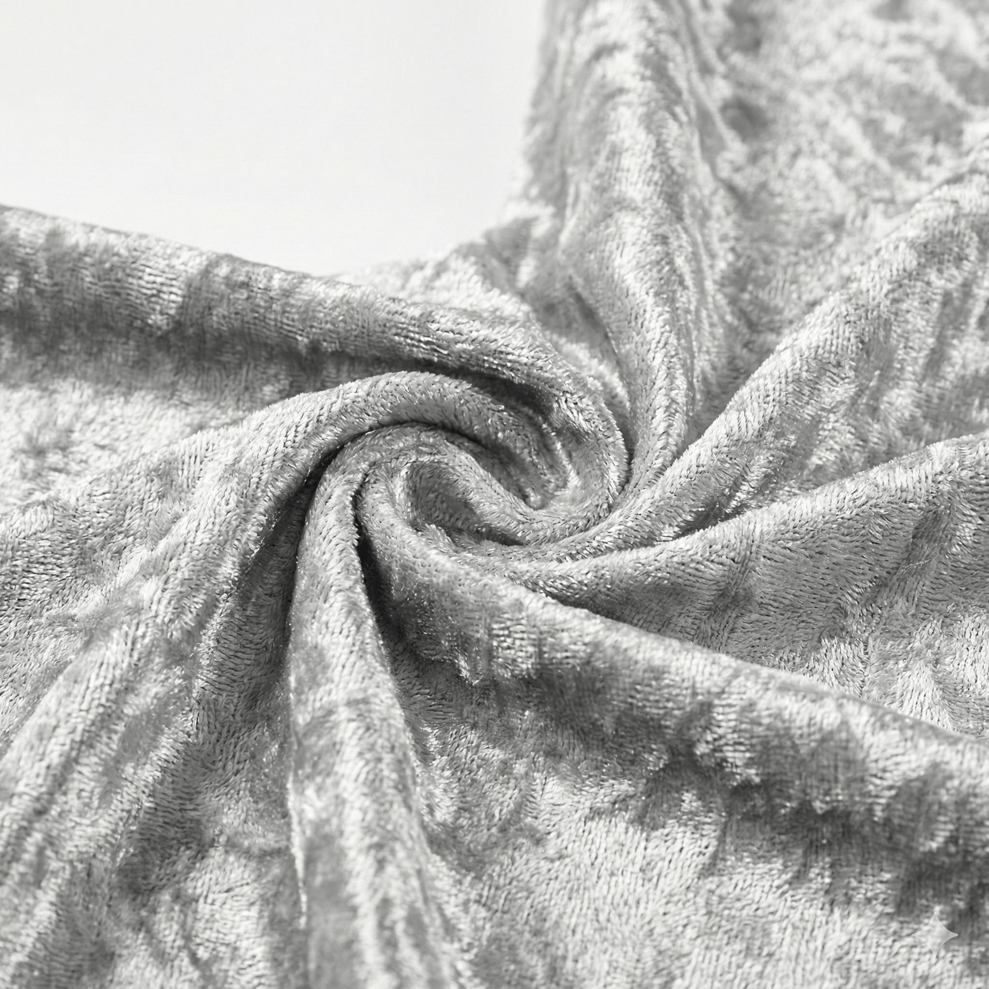 Close-up of textured silver velvet fabric with folds