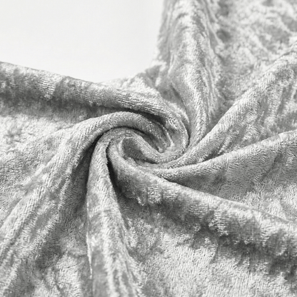 Close-up of textured silver velvet fabric with folds