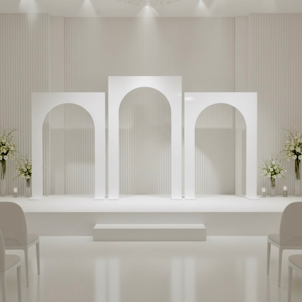 Modern interior design with white wedding arches and floral arrangements.