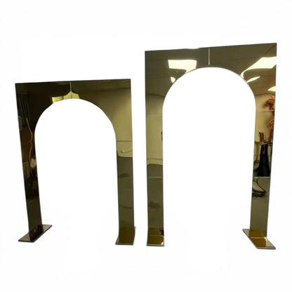 Two metallic arch-shaped wedding backdrops on a white background
