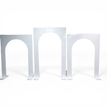 Three white metal wedding backdrops on a white background
