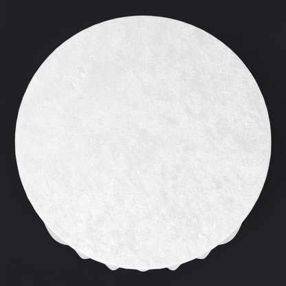 White circular table draped with a white velvet tablecloth on a black background