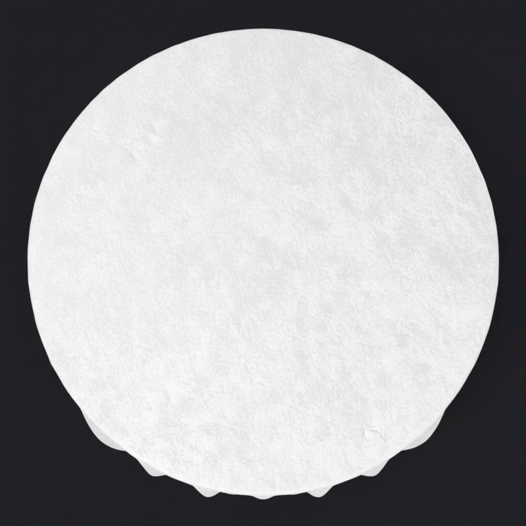 White circular table draped with a white velvet tablecloth on a black background