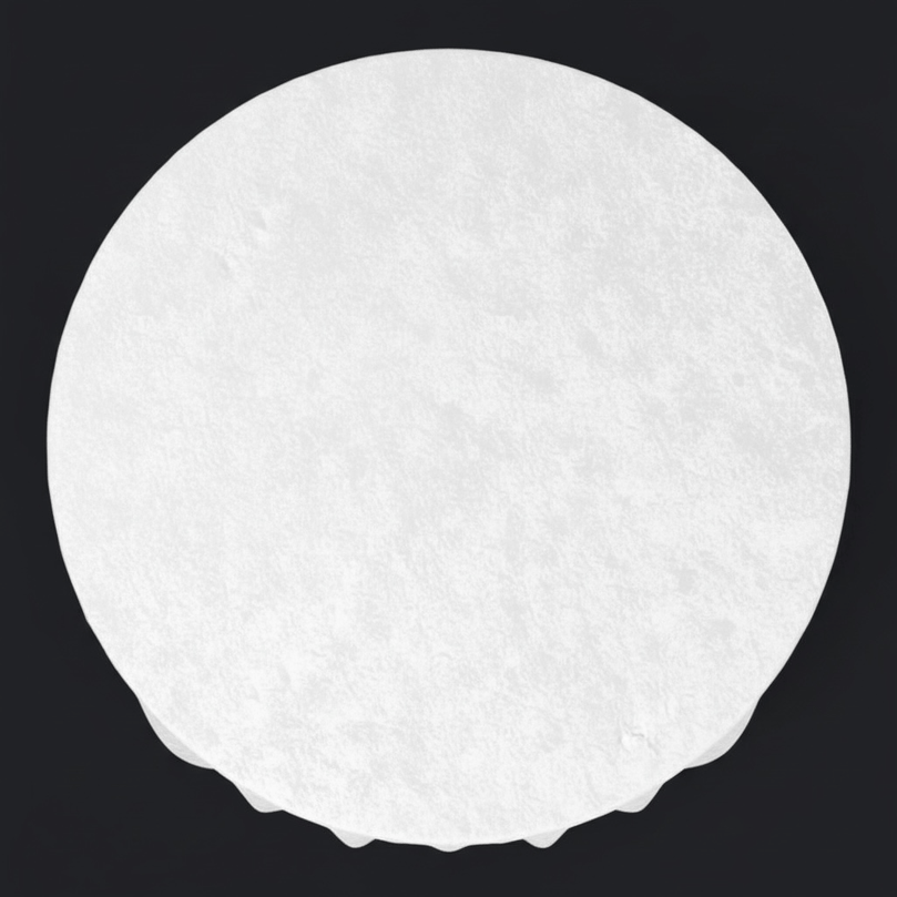 White circular table draped with a white velvet tablecloth on a black background